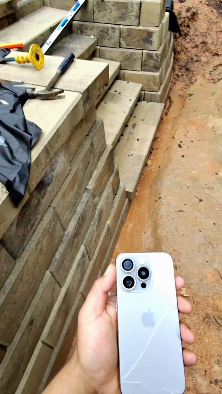 Day 3 on this retaining wall project. Everything was going smoothly until the rain rolled in. 🌧️ During the process, we uncovered a drainage issue that will be addressed with a catch basin as part of a change order. Stay tuned for the transformation. 💪🧱 #drainage #rain #landscape #retainingwall #block